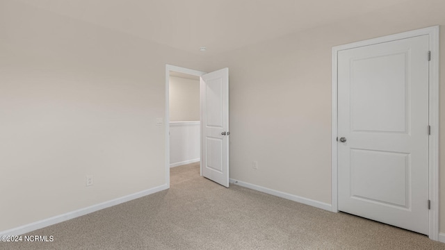 unfurnished bedroom with light colored carpet