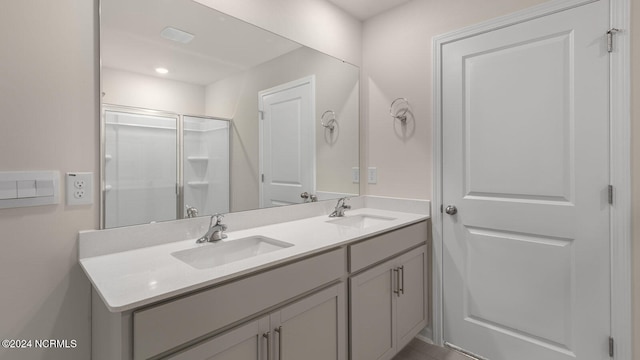 bathroom featuring walk in shower and vanity