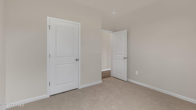 unfurnished bedroom featuring light colored carpet