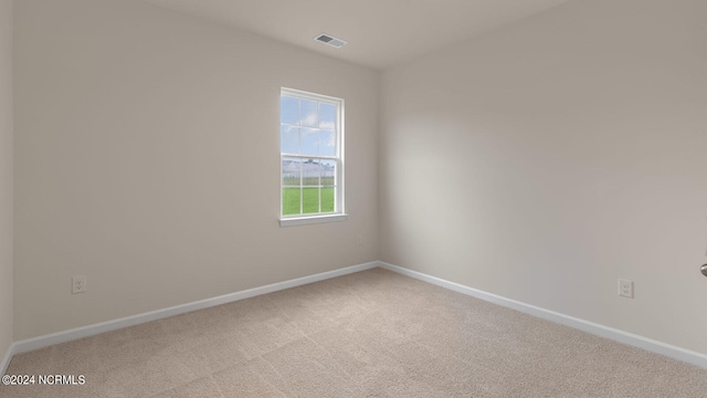 empty room featuring light colored carpet