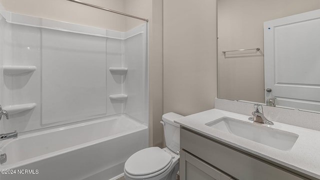 full bathroom with bathing tub / shower combination, vanity, and toilet