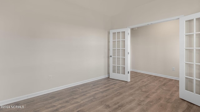 spare room featuring french doors and hardwood / wood-style floors