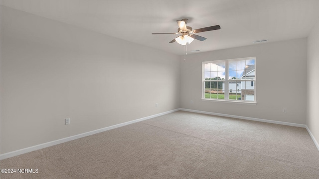 spare room featuring ceiling fan and carpet flooring