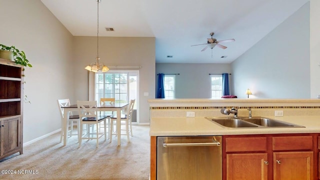 kitchen featuring light carpet, open floor plan, light countertops, stainless steel dishwasher, and a sink