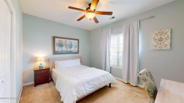 bedroom featuring carpet floors, a ceiling fan, visible vents, and baseboards