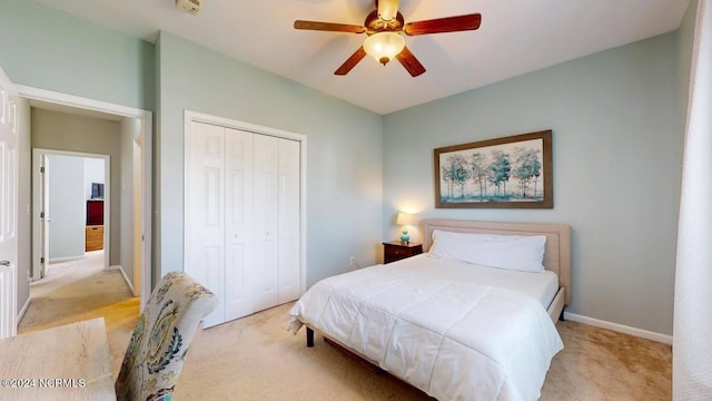 carpeted bedroom with a closet, a ceiling fan, and baseboards