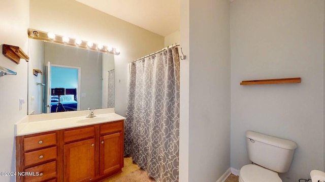 full bath featuring toilet, curtained shower, vanity, and ensuite bathroom