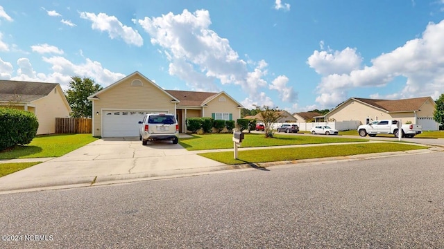 view of front facade featuring an attached garage, fence, concrete driveway, a residential view, and a front lawn