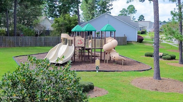 community playground featuring a yard and fence