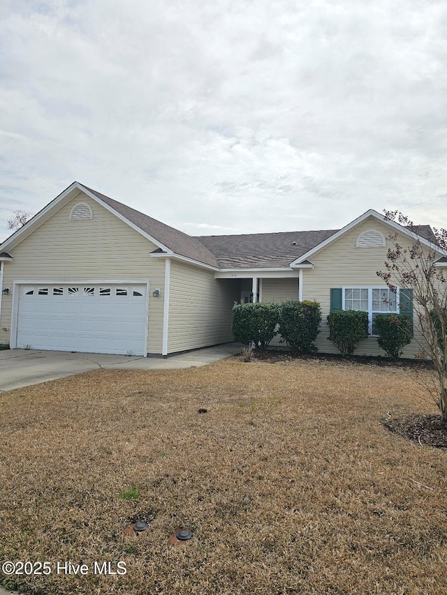 ranch-style home with a front lawn, concrete driveway, and an attached garage