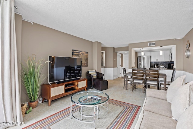 tiled living room with a textured ceiling