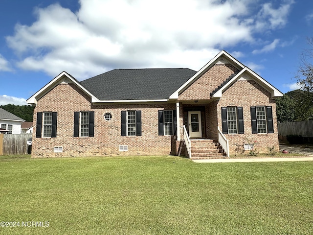 ranch-style house with brick siding, fence, a front lawn, and crawl space