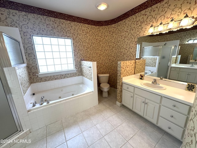 full bathroom with independent shower and bath, vanity, tile patterned flooring, and toilet