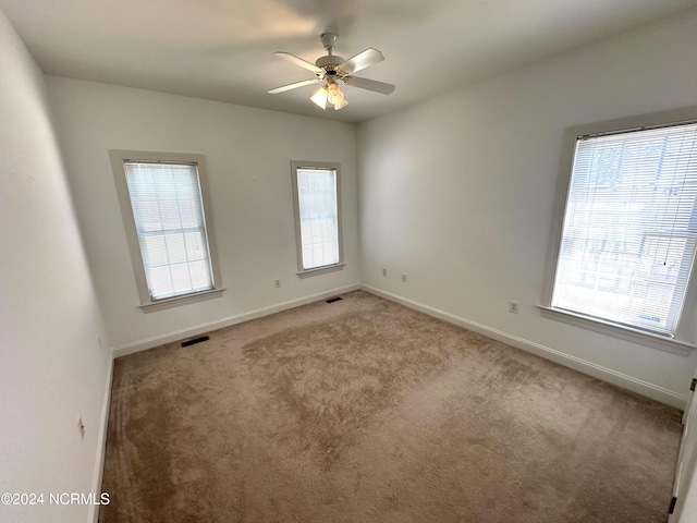 spare room with ceiling fan and carpet flooring