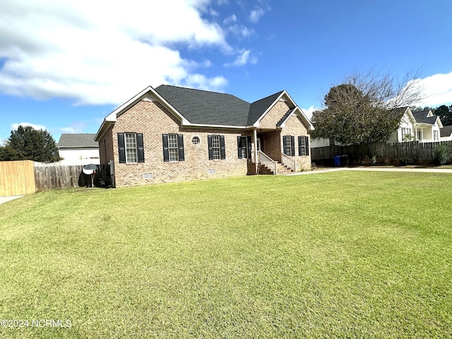 ranch-style house with brick siding, fence, a front lawn, and crawl space