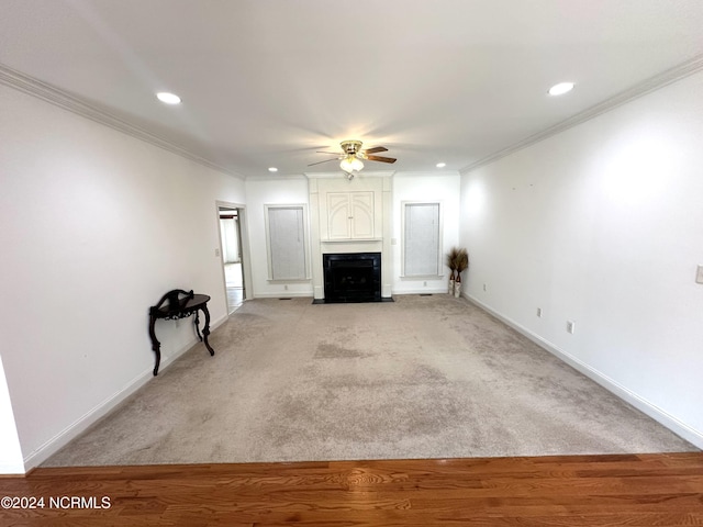 unfurnished living room with a fireplace with flush hearth, crown molding, baseboards, recessed lighting, and a ceiling fan