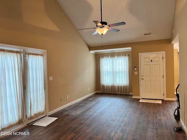 foyer with ceiling fan, a textured ceiling, dark hardwood / wood-style flooring, and high vaulted ceiling