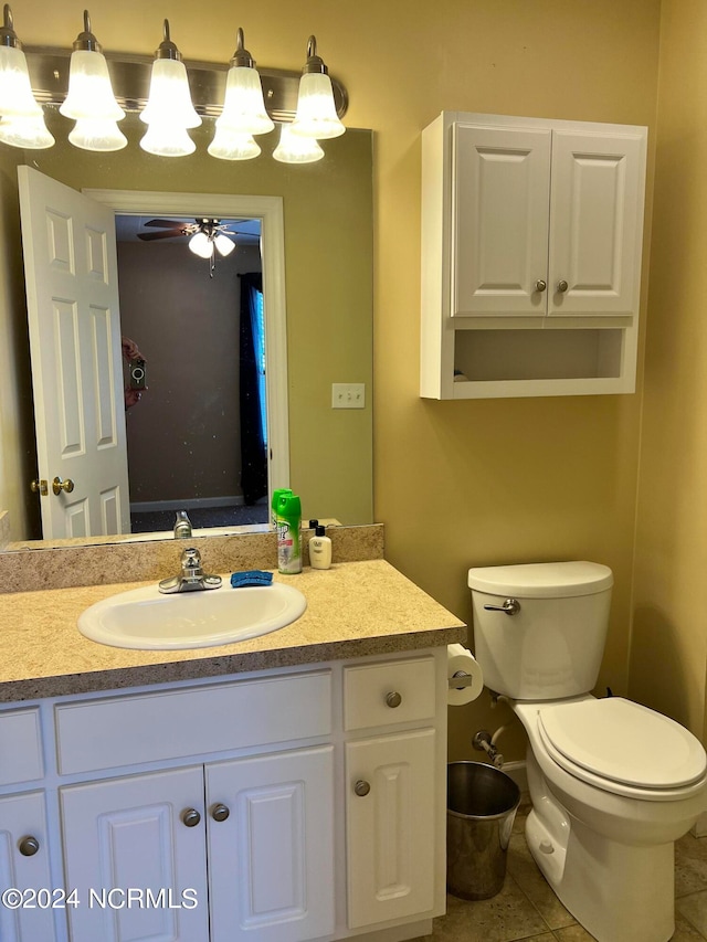 bathroom featuring ceiling fan, vanity, tile patterned flooring, and toilet