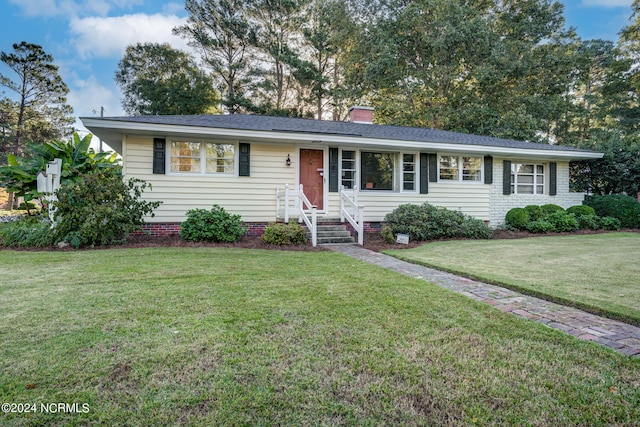 ranch-style home featuring a front lawn