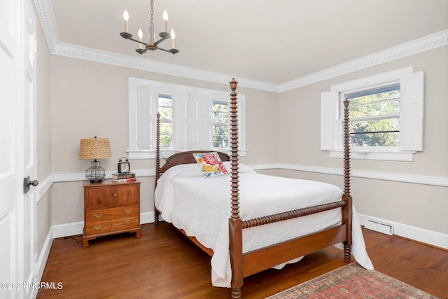 bedroom with an inviting chandelier, crown molding, and hardwood / wood-style floors