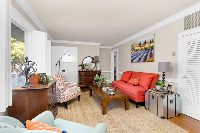 living room featuring light wood-type flooring and crown molding