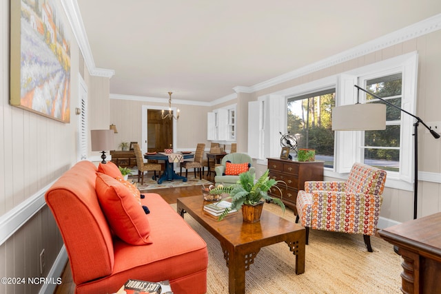 living room featuring a notable chandelier, crown molding, and hardwood / wood-style flooring