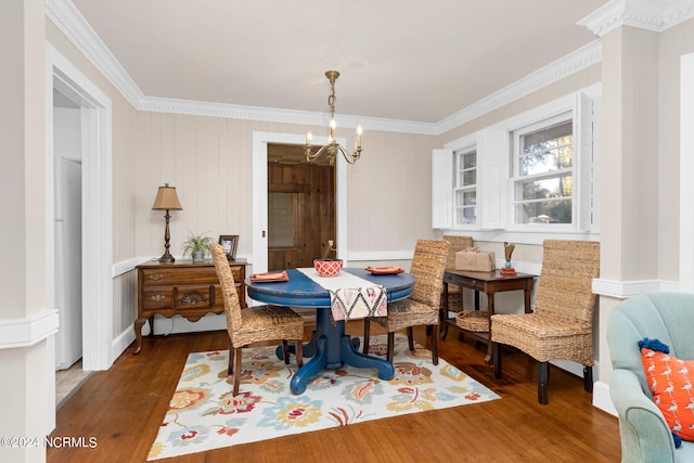 dining room featuring ornamental molding, a chandelier, and dark hardwood / wood-style flooring