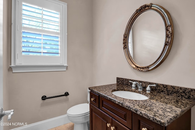 bathroom with vanity, toilet, and tile patterned floors