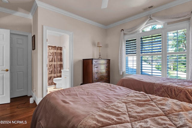 bedroom featuring crown molding, ensuite bathroom, ceiling fan, and dark hardwood / wood-style flooring