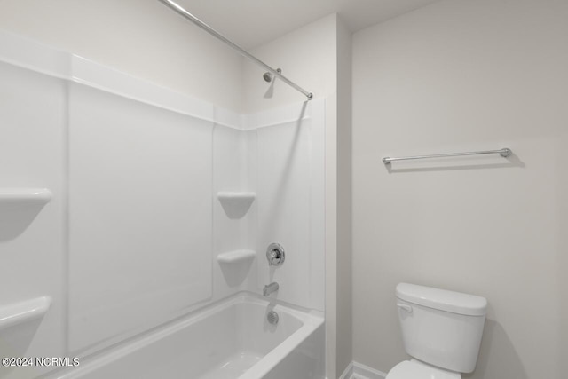 bathroom featuring tub / shower combination and toilet