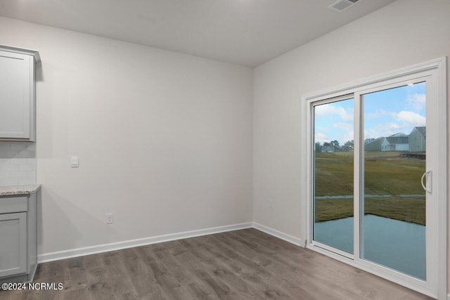 empty room with hardwood / wood-style floors