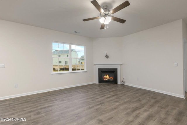 unfurnished living room with ceiling fan and hardwood / wood-style floors