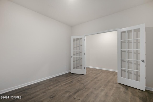 unfurnished room with hardwood / wood-style floors and french doors