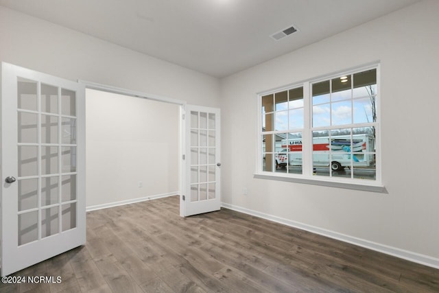 unfurnished room with french doors and hardwood / wood-style flooring