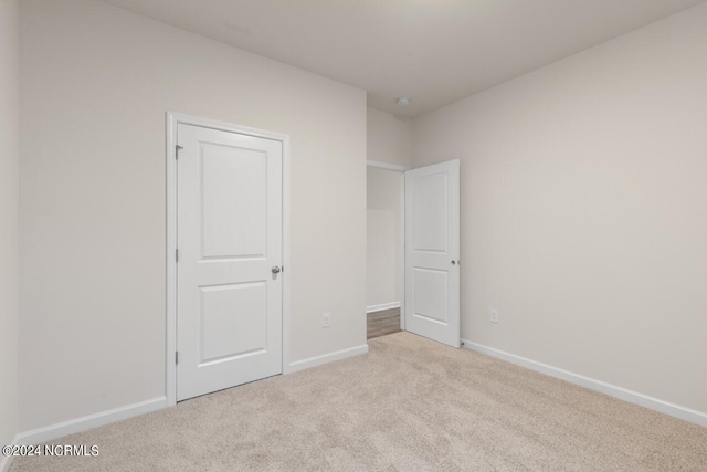 unfurnished bedroom with light carpet