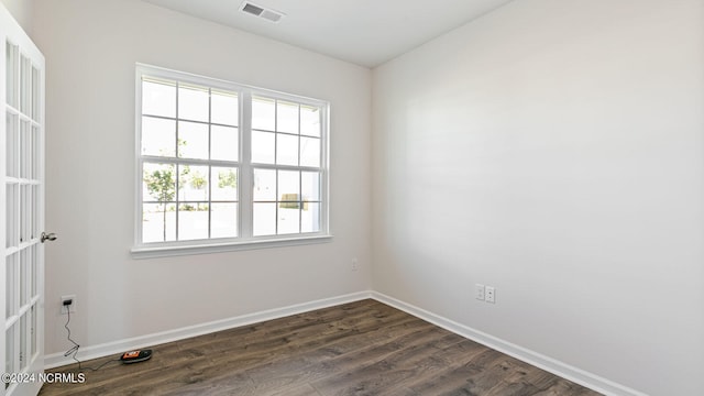 spare room with dark wood-type flooring