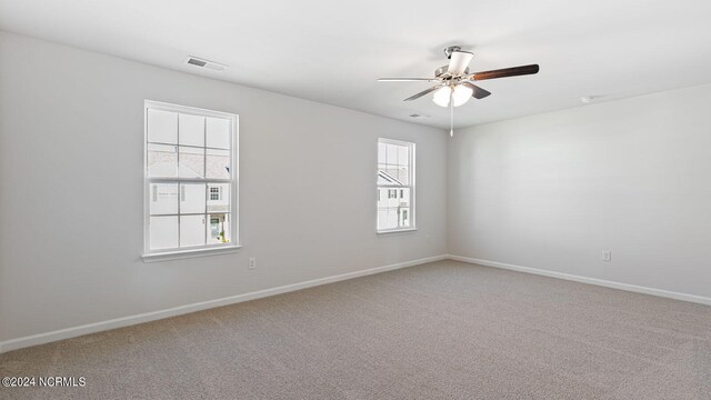 unfurnished room with ceiling fan, plenty of natural light, and carpet