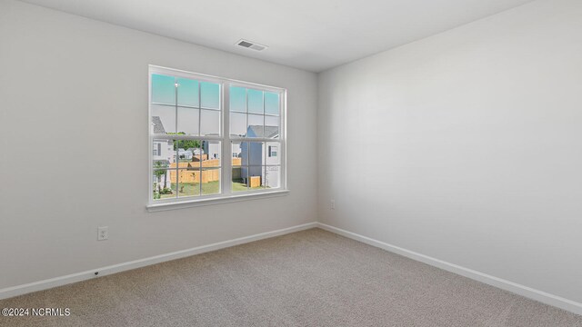 unfurnished room with plenty of natural light and carpet