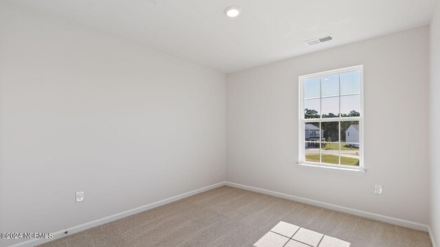 empty room featuring light carpet