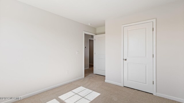 unfurnished bedroom featuring light colored carpet