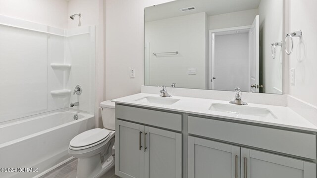 full bathroom featuring shower / tub combination, vanity, and toilet