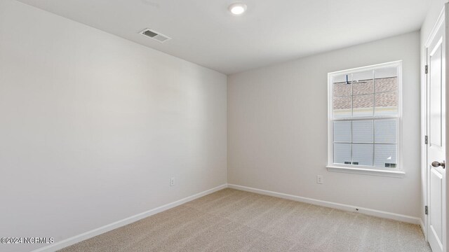 unfurnished room with light carpet