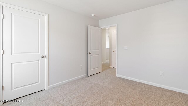 unfurnished bedroom with light carpet