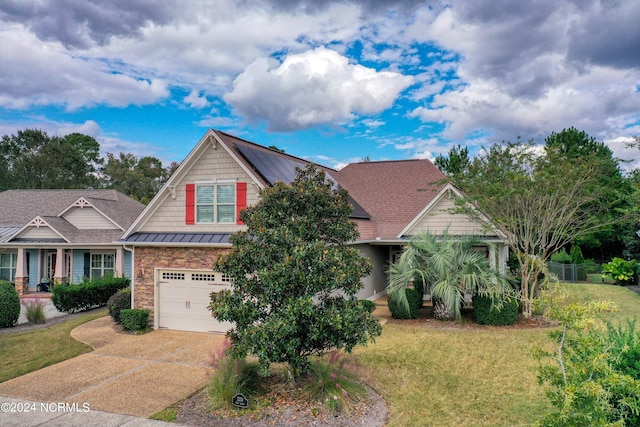 view of front of house featuring a front yard and a garage