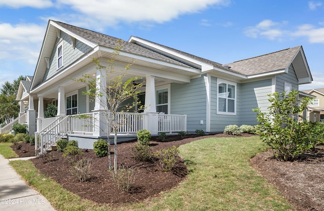 view of front of property featuring a front yard and covered porch