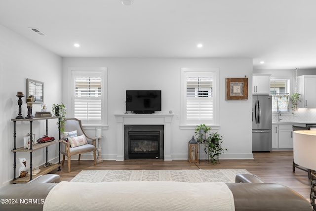 living room with sink and light hardwood / wood-style floors