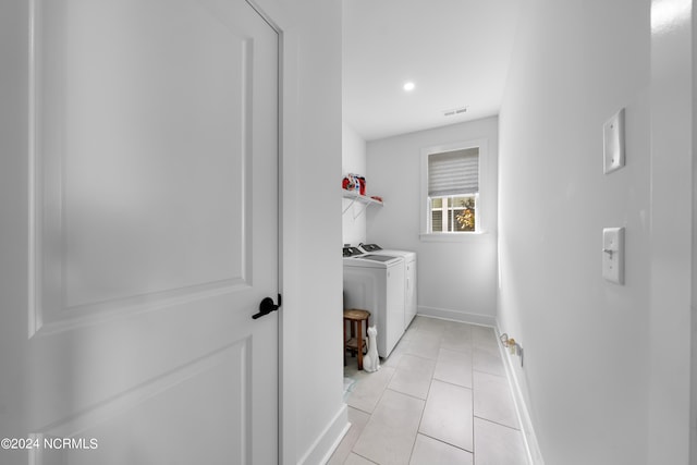 clothes washing area with separate washer and dryer and light tile patterned floors