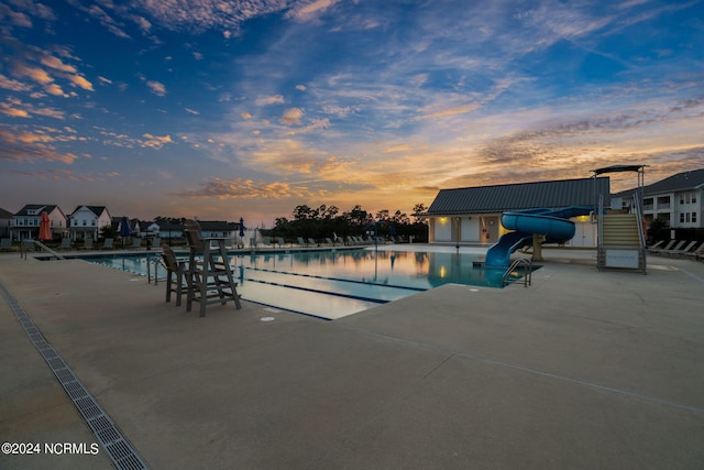 view of pool at dusk