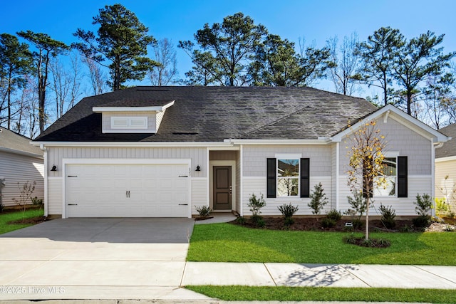 view of front of home with a front lawn and a garage