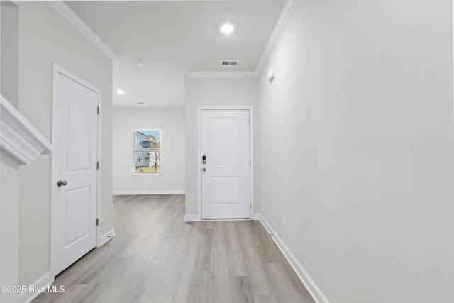 hall featuring light hardwood / wood-style floors and crown molding